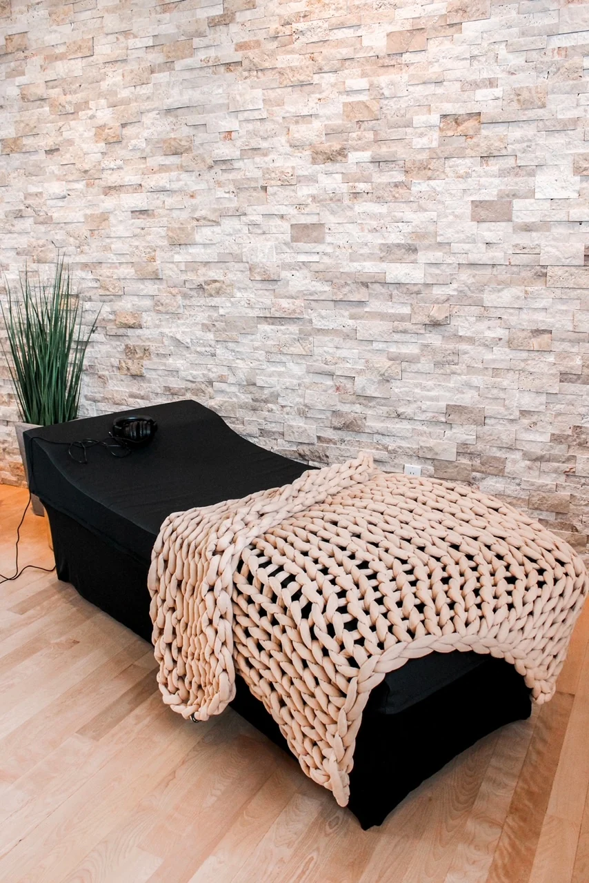 Sensory Lounge with a knitted blanket, shown in manufacturer product photography